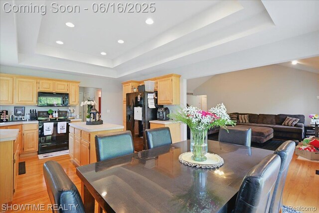 50064 Josephine Dr, Macomb, MI 48044 - dining area with a tray ceiling, light wood-style floors, and recessed lighting