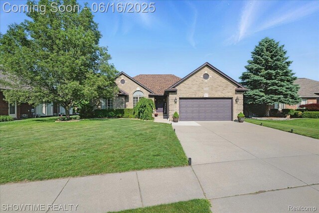 50064 Josephine Dr, Macomb, MI 48044 - view of front of house featuring an attached garage, a front yard, driveway, and brick siding