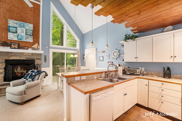 534 N Lighthouse Dr, Mears, MI 49436 - kitchen featuring dishwasher, a peninsula, high vaulted ceiling, decorative light fixtures, and white cabinets