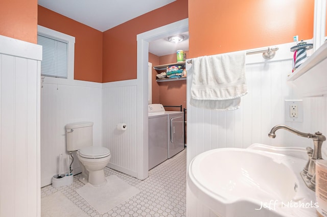 534 N Lighthouse Dr, Mears, MI 49436 - bathroom featuring independent washer and dryer and a wainscoted wall