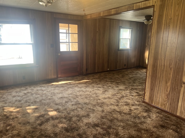 919 Nature Ln, Montgomery, MI 49255 - spare room featuring carpet flooring and wooden walls