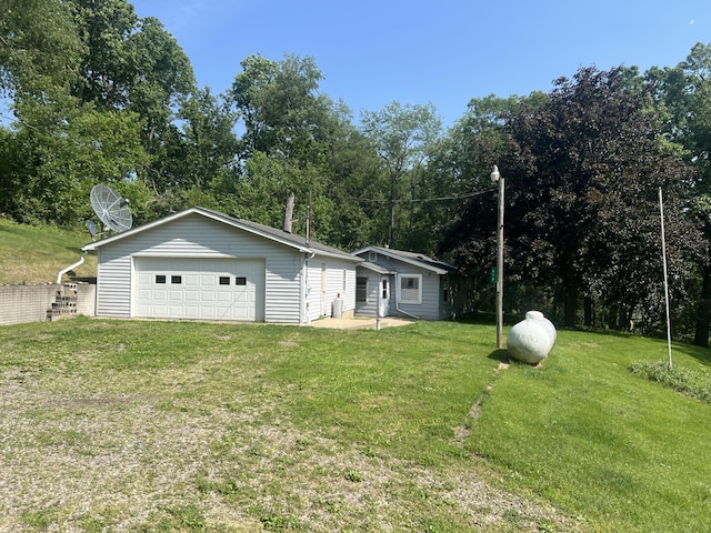 919 Nature Ln, Montgomery, MI 49255 - view of front facade featuring a garage, a front lawn, and an outdoor structure