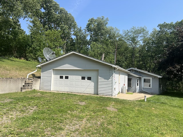 919 Nature Ln, Montgomery, MI 49255 - view of home's exterior with a garage and a lawn