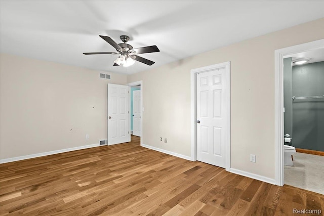 3757 Chase Lake Rd, Howell, MI 48855 - unfurnished bedroom featuring wood finished floors, ensuite bath, and ceiling fan