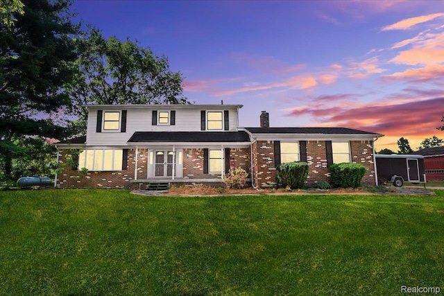 3757 Chase Lake Rd, Howell, MI 48855 - traditional home featuring brick siding, a chimney, and a lawn