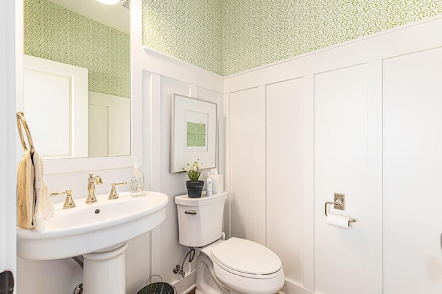 2377 Lake Birch Ct NE, Grand Rapids, MI 49525 - bathroom with toilet and a decorative wall