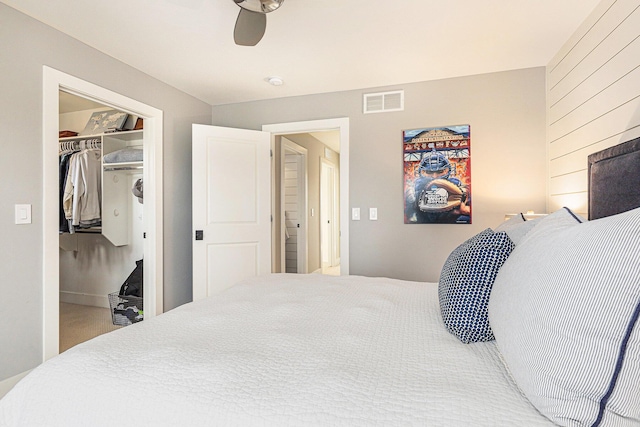 2377 Lake Birch Ct NE, Grand Rapids, MI 49525 - bedroom featuring a walk in closet, a closet, and a ceiling fan