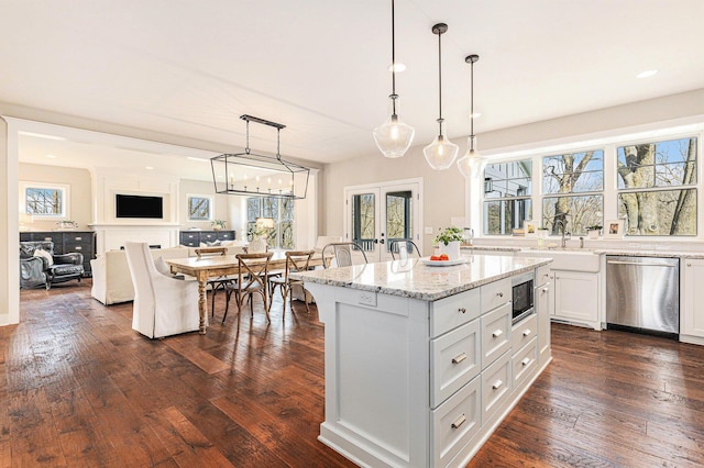 2377 Lake Birch Ct NE, Grand Rapids, MI 49525 - kitchen with stainless steel appliances, healthy amount of natural light, white cabinets, open floor plan, and recessed lighting