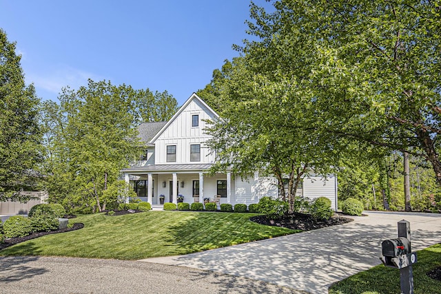 2377 Lake Birch Ct NE, Grand Rapids, MI 49525 - modern farmhouse featuring a porch, board and batten siding, a standing seam roof, concrete driveway, and a front yard