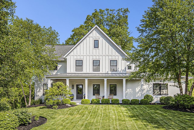 2377 Lake Birch Ct NE, Grand Rapids, MI 49525 - modern farmhouse style home featuring a porch, board and batten siding, a front lawn, a standing seam roof, and a metal roof