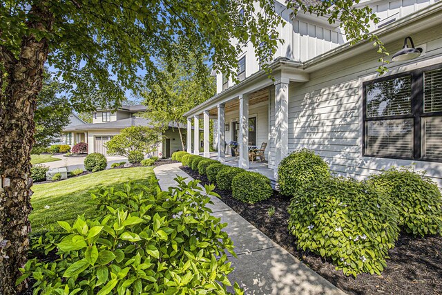 2377 Lake Birch Ct NE, Grand Rapids, MI 49525 - view of side of property with board and batten siding and a porch
