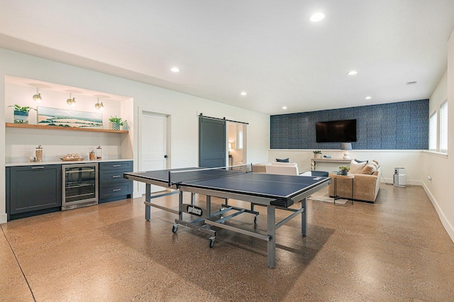 2377 Lake Birch Ct NE, Grand Rapids, MI 49525 - playroom with wine cooler, bar, a barn door, recessed lighting, and wallpapered walls