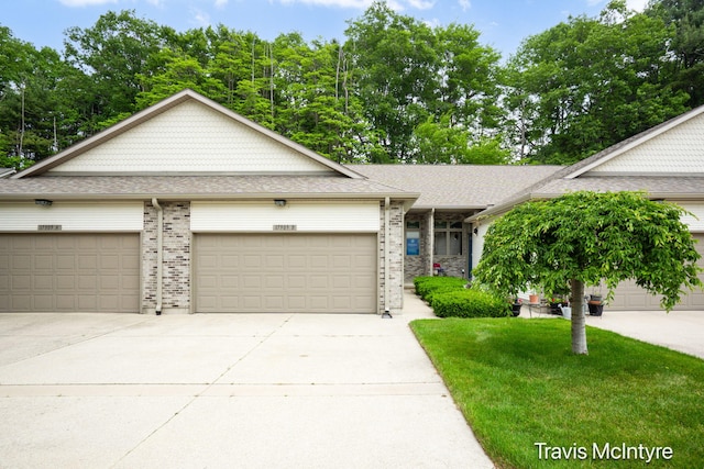 17909 Hidden Dunes Ln Unit B, Spring Lake, MI 49456 - view of front of house with driveway, brick siding, a garage, and a front yard