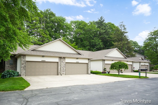 17909 Hidden Dunes Ln Unit B, Spring Lake, MI 49456 - view of front facade featuring driveway, a garage, brick siding, and a shingled roof