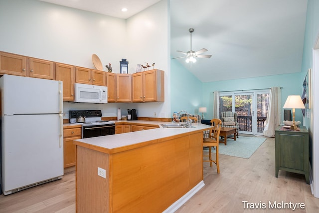 17909 Hidden Dunes Ln Unit B, Spring Lake, MI 49456 - kitchen featuring white appliances, high vaulted ceiling, a peninsula, light wood finished floors, and a ceiling fan