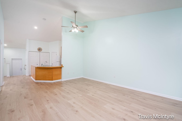 17909 Hidden Dunes Ln Unit B, Spring Lake, MI 49456 - unfurnished living room with a ceiling fan, light wood-type flooring, high vaulted ceiling, and recessed lighting