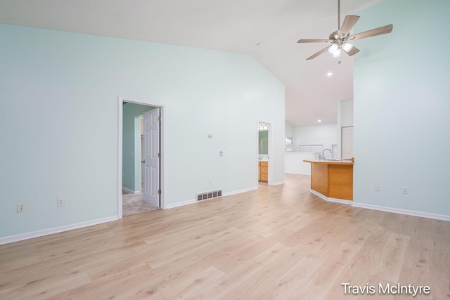 17909 Hidden Dunes Ln Unit B, Spring Lake, MI 49456 - unfurnished living room with high vaulted ceiling, light wood-style floors, and ceiling fan