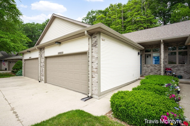 17909 Hidden Dunes Ln Unit B, Spring Lake, MI 49456 - view of side of property with a garage, driveway, and brick siding
