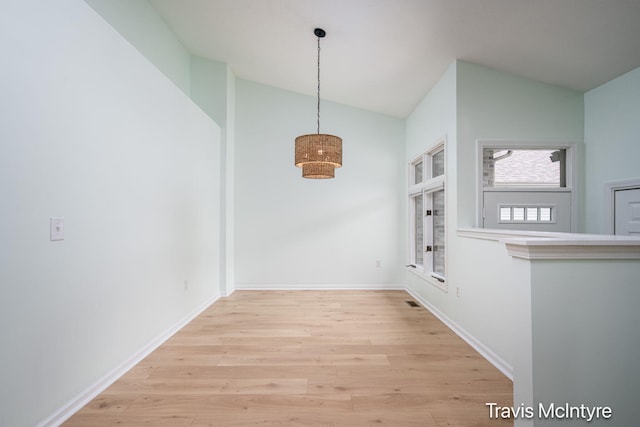 17909 Hidden Dunes Ln Unit B, Spring Lake, MI 49456 - unfurnished dining area featuring vaulted ceiling and wood finished floors