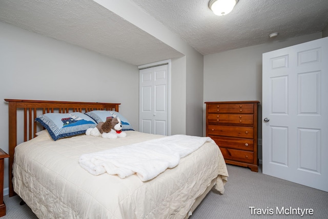 17909 Hidden Dunes Ln Unit B, Spring Lake, MI 49456 - bedroom with carpet floors, a closet, and a textured ceiling
