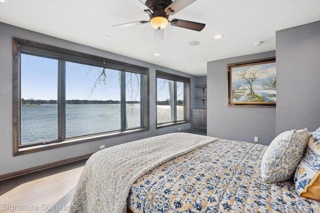 3806 Island Park Dr, Waterford, MI 48329 - bedroom with a water view, multiple windows, recessed lighting, ceiling fan, and wood finished floors
