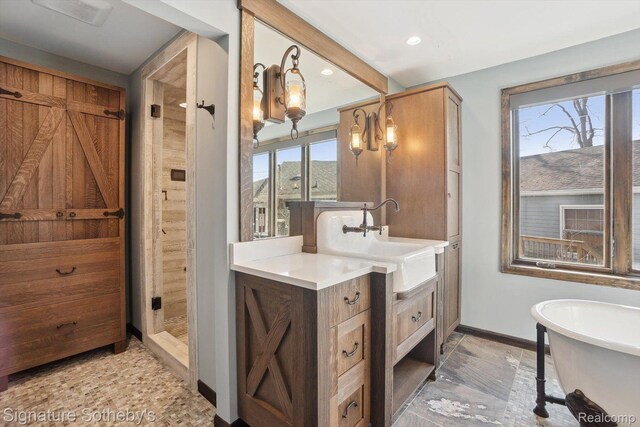 3806 Island Park Dr, Waterford, MI 48329 - bathroom featuring vanity, a soaking tub, tiled shower, and recessed lighting