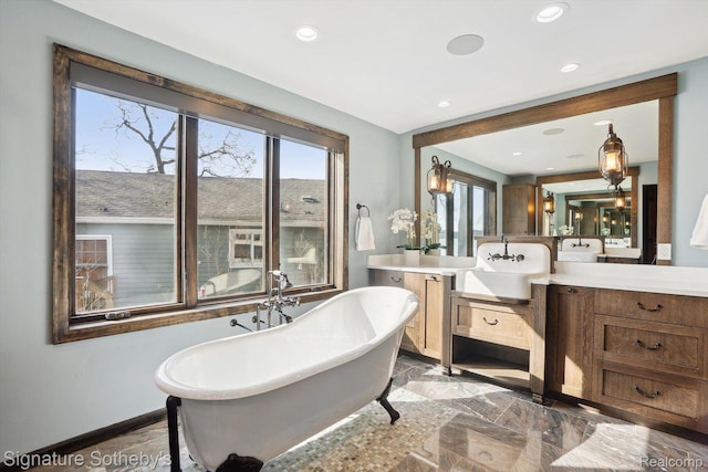 3806 Island Park Dr, Waterford, MI 48329 - full bathroom with a soaking tub, vanity, plenty of natural light, recessed lighting, and marble tiled flooring