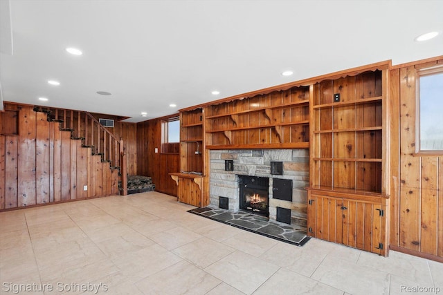 3806 Island Park Dr, Waterford, MI 48329 - unfurnished living room featuring wooden walls, stairway, recessed lighting, and a stone fireplace