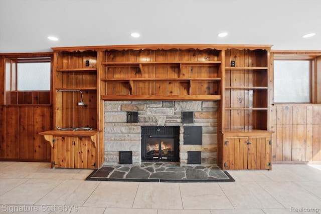3806 Island Park Dr, Waterford, MI 48329 - living room with a stone fireplace, recessed lighting, and wood walls