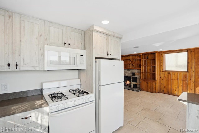3806 Island Park Dr, Waterford, MI 48329 - kitchen with white appliances, dark countertops, a fireplace, wooden walls, and recessed lighting