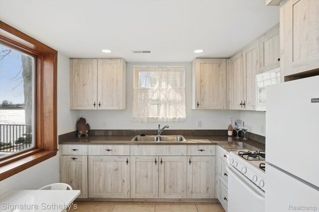 3806 Island Park Dr, Waterford, MI 48329 - kitchen featuring white appliances, dark countertops, recessed lighting, and light tile patterned flooring