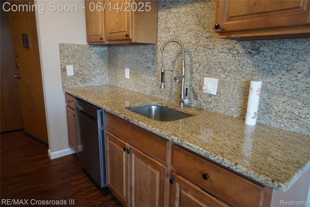 250 N Liberty St Unit 310, Belleville, MI 48111 - kitchen featuring stainless steel dishwasher, dark wood-style flooring, backsplash, light stone countertops, and brown cabinets