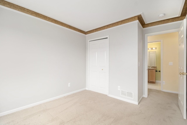2756 Barclay Way, Ann Arbor, MI 48105 - unfurnished bedroom with light carpet, crown molding, and a closet