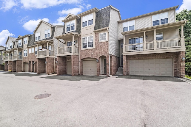 2756 Barclay Way, Ann Arbor, MI 48105 - view of front of property with brick siding, a residential view, a garage, driveway, and a balcony