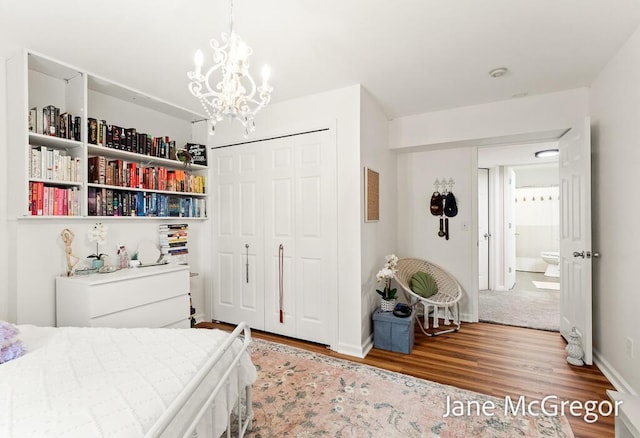 15159 Westray St, Grand Haven, MI 49417 - bedroom featuring wood finished floors, a closet, and a chandelier