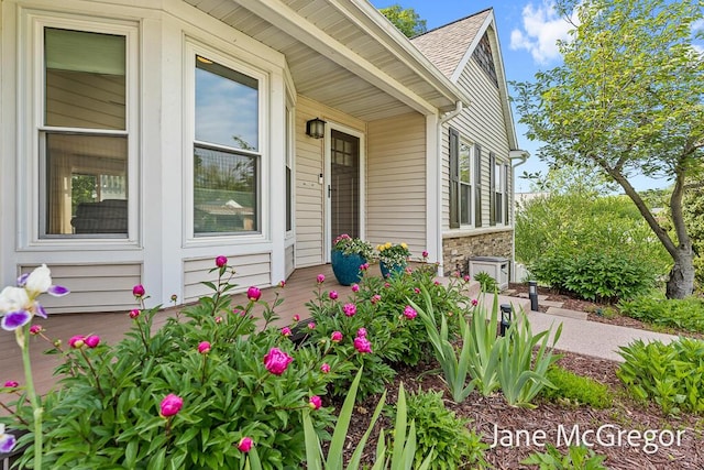 15159 Westray St, Grand Haven, MI 49417 - doorway to property featuring stone siding and a shingled roof