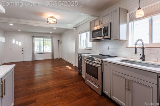1904 Academy St, Ferndale, MI 48220 - kitchen with appliances with stainless steel finishes, gray cabinetry, beamed ceiling, tasteful backsplash, and light countertops