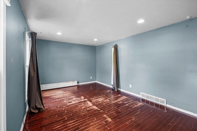 2144 Stanford Dr SE, Kentwood, MI 49508 - spare room with a baseboard radiator, wood finished floors, and recessed lighting