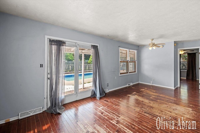 2144 Stanford Dr SE, Kentwood, MI 49508 - unfurnished room with a ceiling fan, wood-type flooring, and a textured ceiling