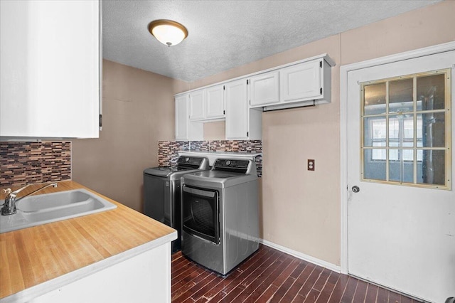 2144 Stanford Dr SE, Kentwood, MI 49508 - laundry room featuring washer and clothes dryer, a textured ceiling, and dark wood-style flooring