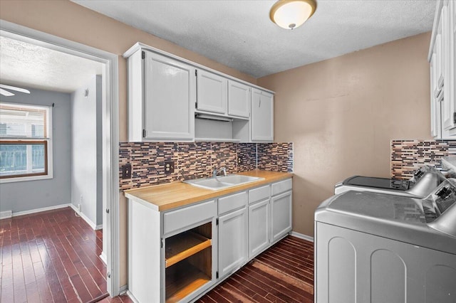 2144 Stanford Dr SE, Kentwood, MI 49508 - laundry room with washer and dryer, a textured ceiling, dark wood-type flooring, and a ceiling fan