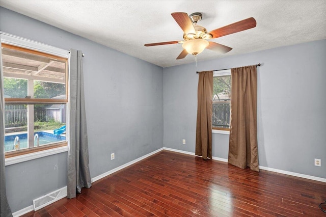 2144 Stanford Dr SE, Kentwood, MI 49508 - empty room with hardwood / wood-style floors, a ceiling fan, and a textured ceiling
