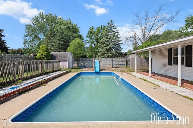 2144 Stanford Dr SE, Kentwood, MI 49508 - view of swimming pool featuring a fenced backyard, a shed, and a patio area