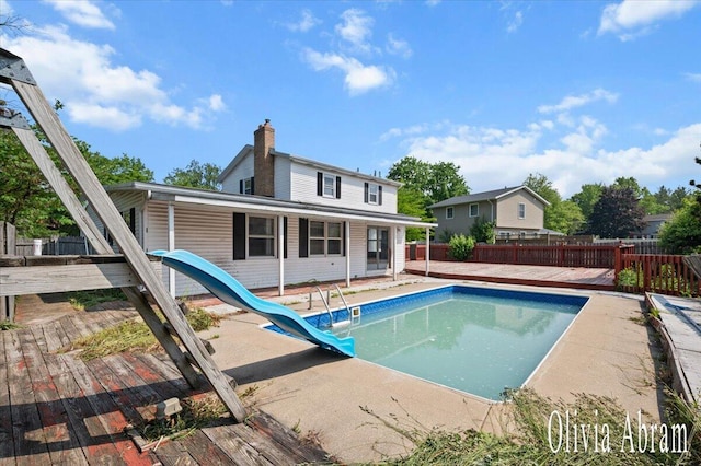 2144 Stanford Dr SE, Kentwood, MI 49508 - view of swimming pool with a water slide, a deck, a fenced backyard, and a patio area