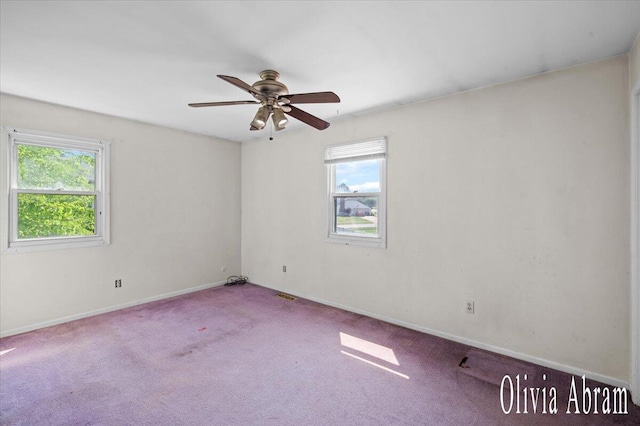 2144 Stanford Dr SE, Kentwood, MI 49508 - empty room featuring plenty of natural light, carpet floors, and a ceiling fan