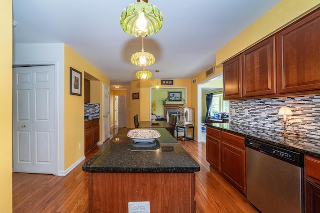 5992 Cedar Ridge Dr, Ann Arbor, MI 48103 - kitchen with dishwasher, wood finished floors, decorative backsplash, dark stone counters, and a kitchen island