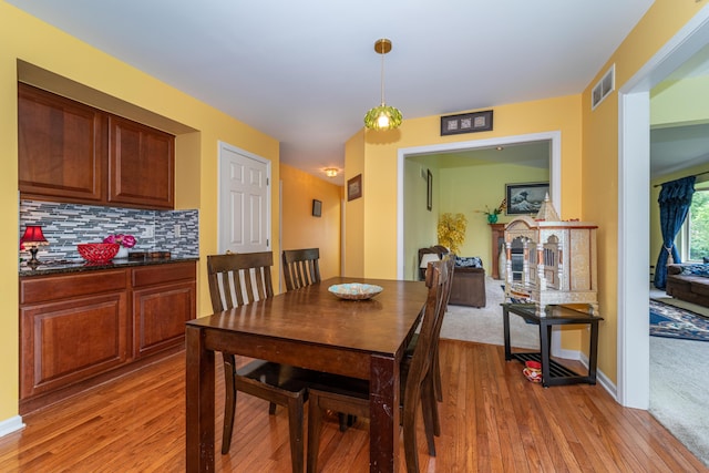 5992 Cedar Ridge Dr, Ann Arbor, MI 48103 - dining room featuring light wood-style floors and a fireplace