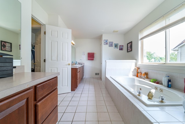 5992 Cedar Ridge Dr, Ann Arbor, MI 48103 - bathroom with vanity, a jetted tub, and tile patterned floors