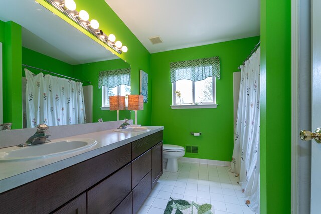 5992 Cedar Ridge Dr, Ann Arbor, MI 48103 - full bathroom featuring double vanity, tile patterned flooring, and curtained shower
