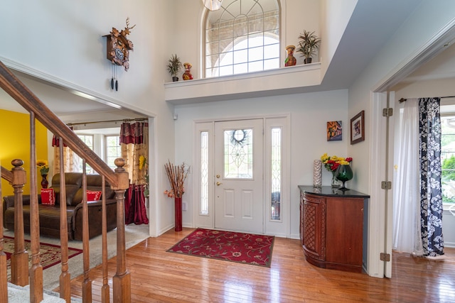 5992 Cedar Ridge Dr, Ann Arbor, MI 48103 - foyer featuring healthy amount of natural light, stairs, light wood-type flooring, and a high ceiling